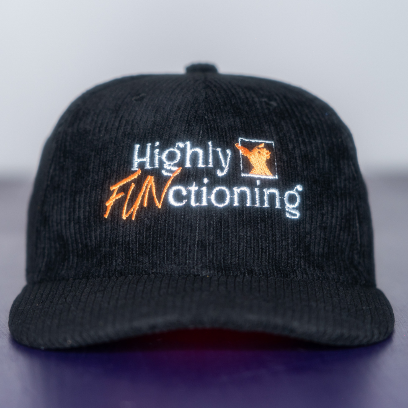 A black corduroy baseball cap with 'Highly FUNctioning' and a kangaroo embroidered in white and orange on the front.