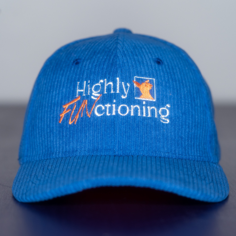 A blue colored corduroy baseball cap with 'Highly FUNctioning' and a kangaroo embroidered in white and orange on the front.